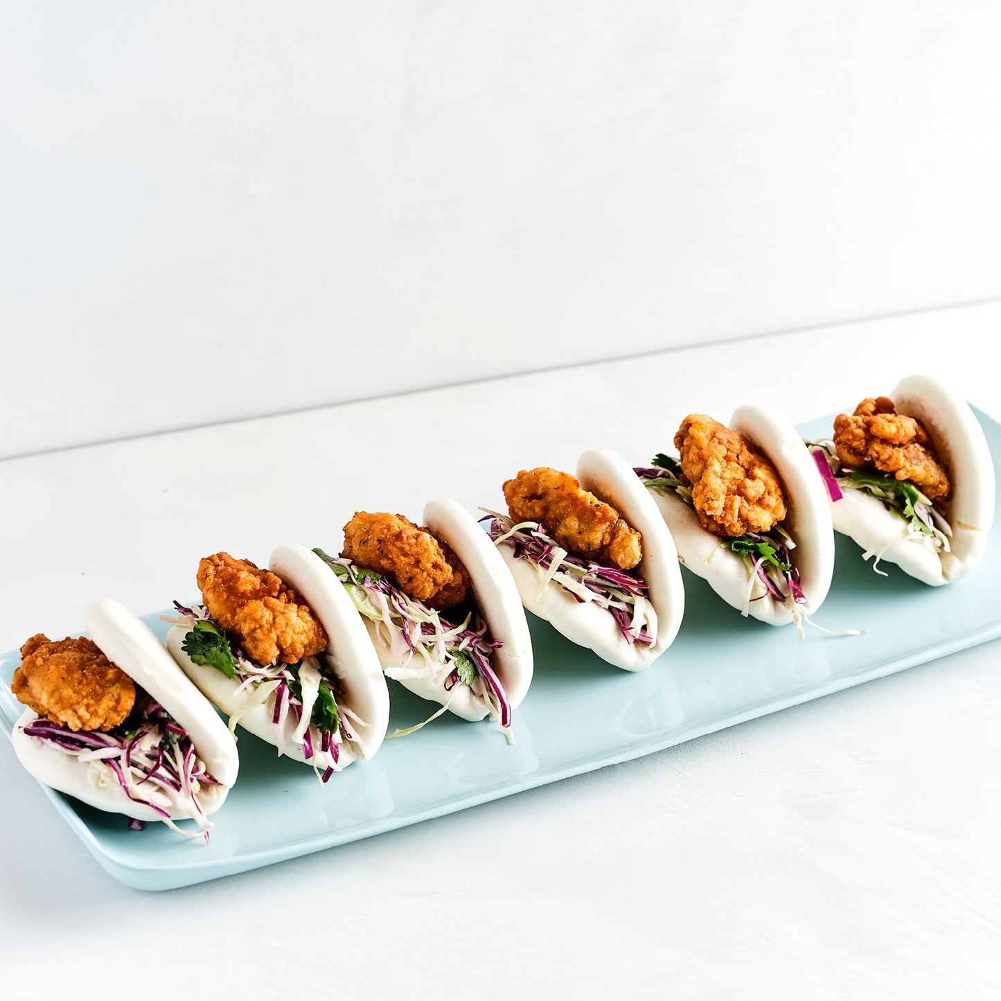 POPCORN CHICKEN BAO, CHIPOTLE MAYO, CABBAGE SLAW, PICKLED CUCUMBER (30)