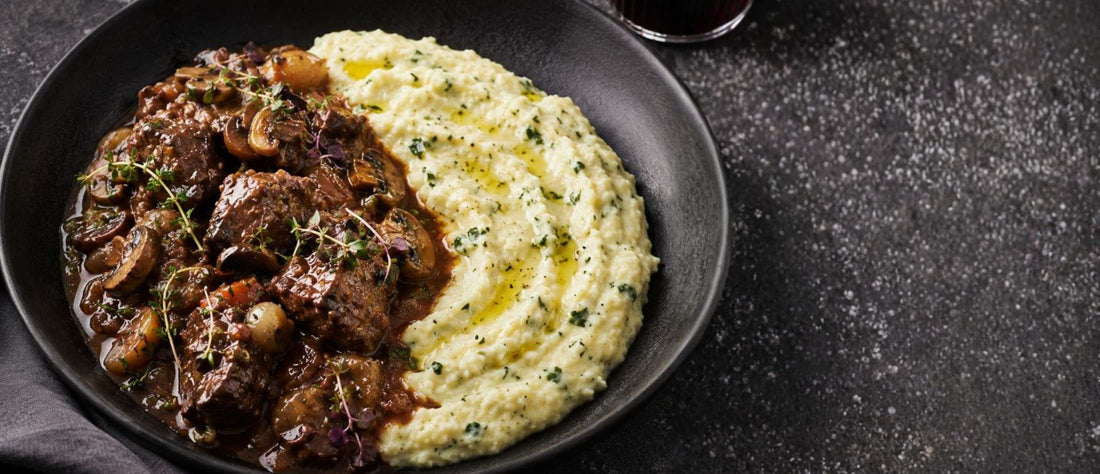 a bowl of beef bourguignon with soft mascarpone & parmesan polenta