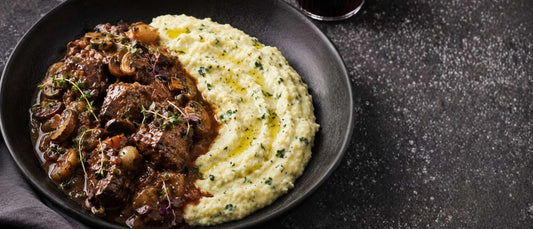 a bowl of beef bourguignon with soft mascarpone & parmesan polenta