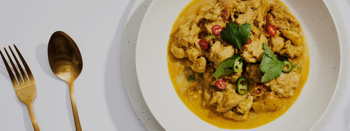 A close-up overhead shot of BLAKEAWAY's butter chicken with cashews
