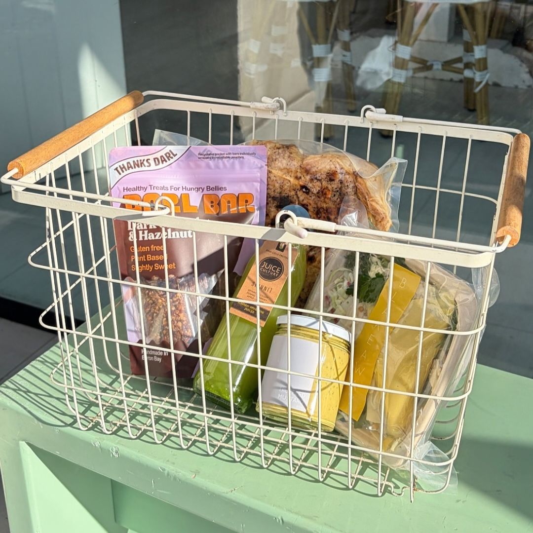 A shopping basket with Dark Chocolate & Hazelnut Darl Bar, the Ultimate Roast Chook, Cabbage & Broccoli Slaw, Juice Culture Skinni Juice and a jar of Truffled Mustard