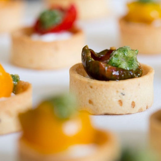 Small tartlets with heirloom tomatos, goats curd and salsa verde