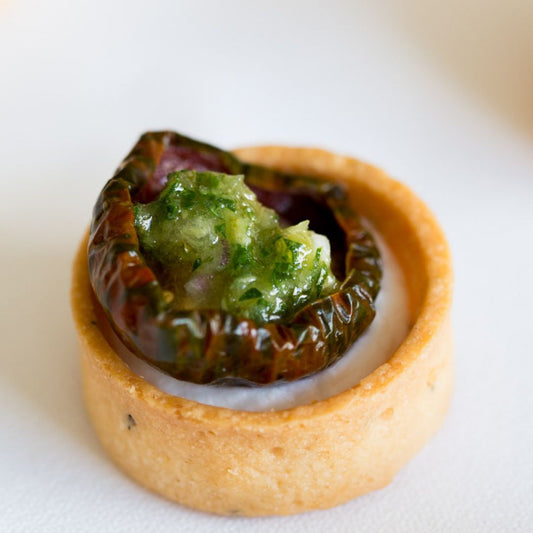 Small tartlets with heirloom tomatos, goats curd and salsa verde