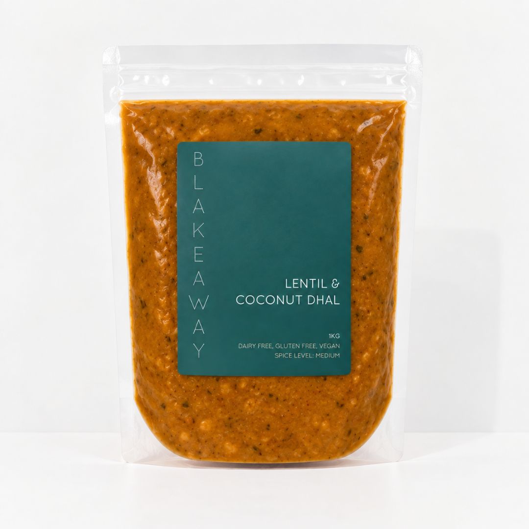 A clear stand-up pouch of BLAKEAWAY's Lentil & Coconut Dhal containing an orange-brown lentil sauce, with a dark teal label on the front, set against a plain white background.
