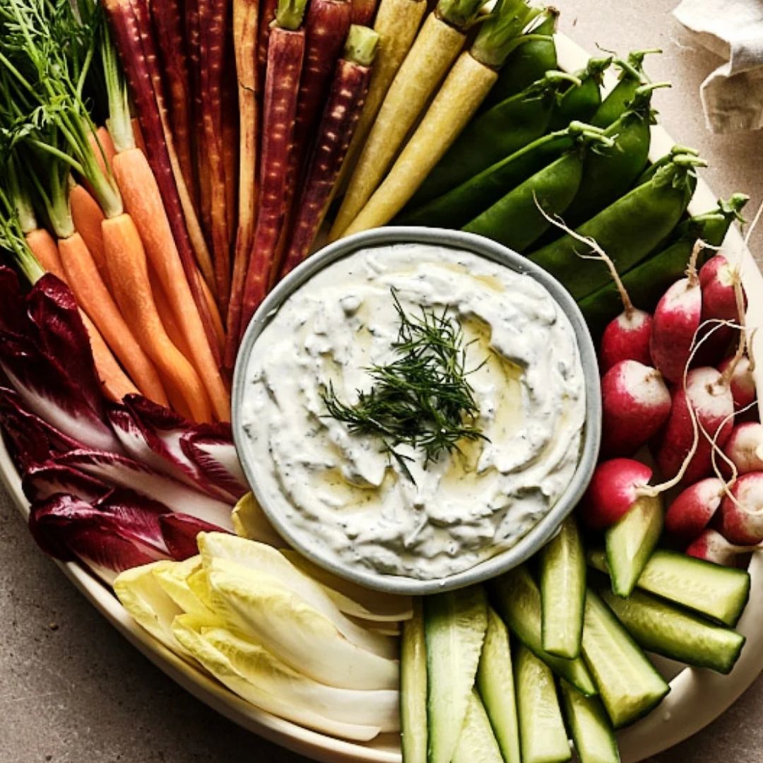 Platter of fresh vegetables with a bowl of tzatziki