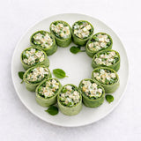 Green Waldorf chicken wraps with filling on a white plate